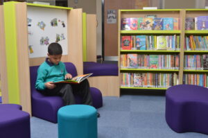 Boy reading in primary school library