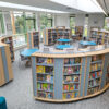 curved shelves in high school library with teaching space in the middle