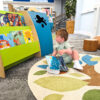 toddler reading picturebooks in children's library