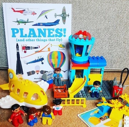 Book about planes with toys around it