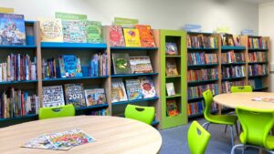 school library shelving with tables and chairs