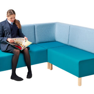 Teenager sitting and reading on double seats and corner seat in school library