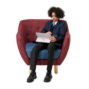 Student sitting on library tub chair