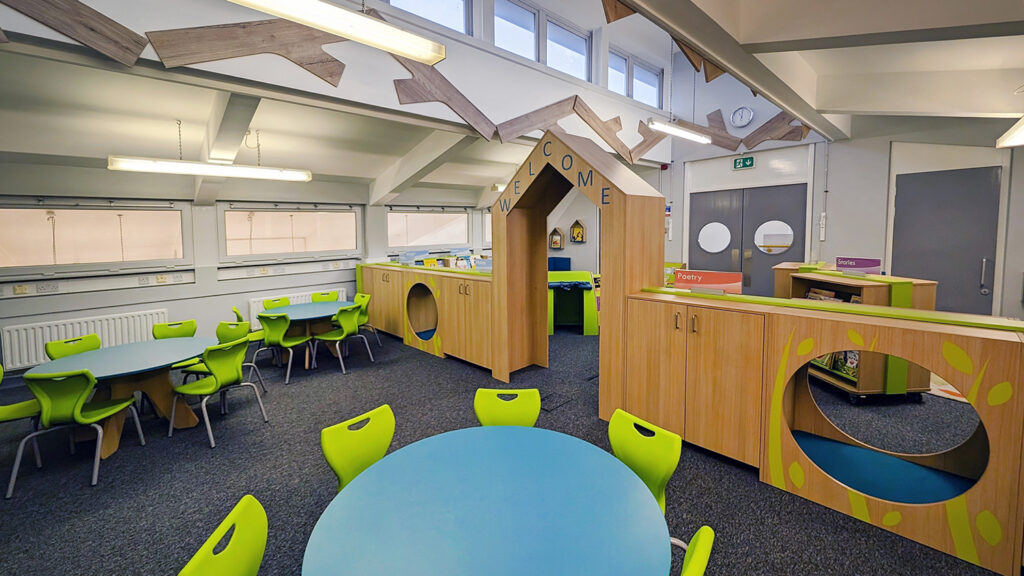 PRIMARY SCHOOL LIBRARY WITH SHELVING STORAGE AND TABLES AND CHAIRS