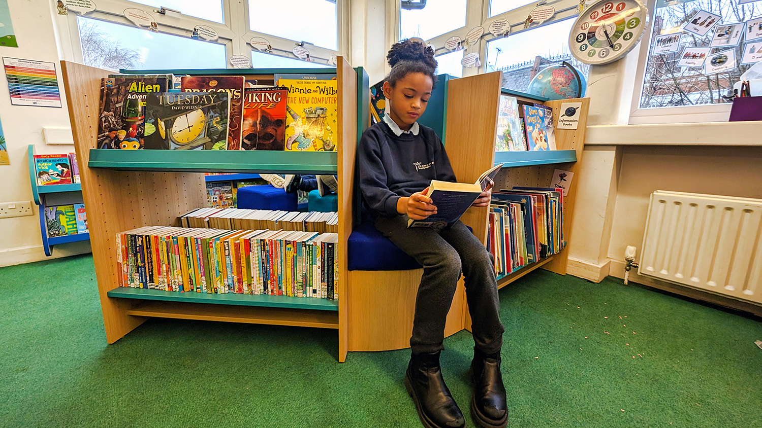 GIRL READING IN BOOK CORNER SCHOOL