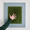 child touching tactile grass astro turf sensory frame