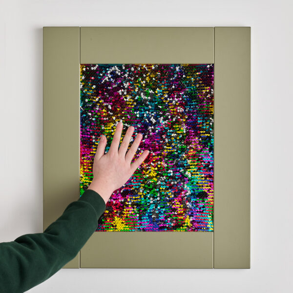 child touching tactile sequin sensory frame