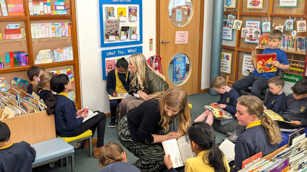 lunchtime school book club in primary school with children reading